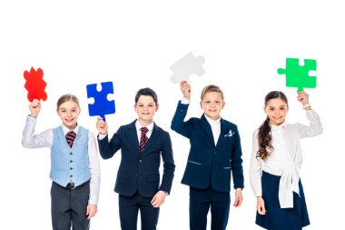 happy kids in formal wear holding puzzle pieces Isolated On White clipart
