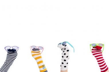 cropped view of people with colorful sock puppets and sunglasses on hands Isolated On White  clipart