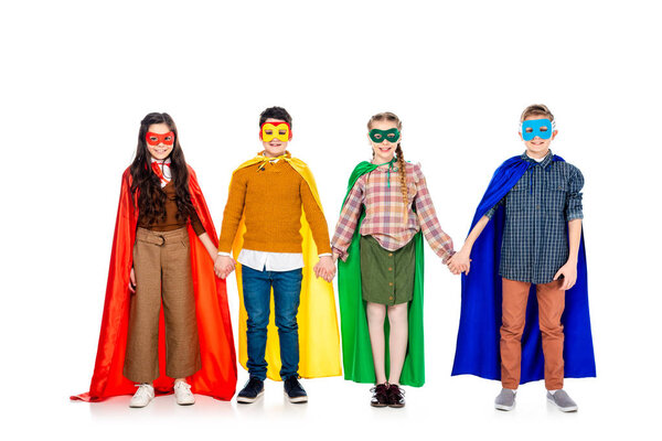 happy kids in superhero costumes and masks holding hands On White