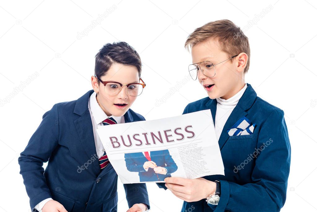 schoolboys pretending to be businessmen reading newspaper Isolated On White 