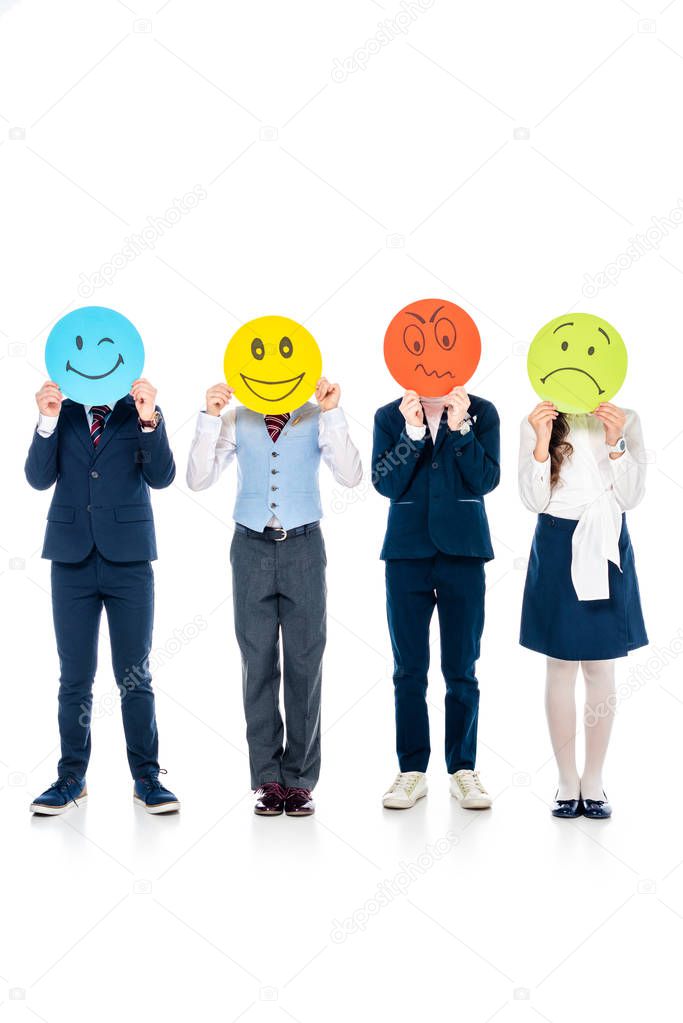 schoolchildren in formal wear covering faces with cards with various face expressions On White