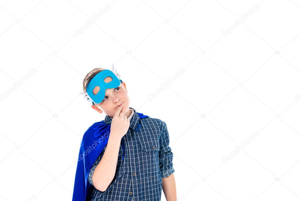 pensive boy in superhero costume touching chin Isolated On White with copy space