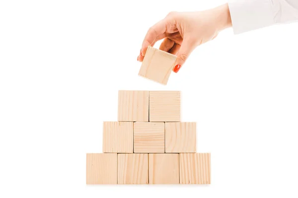 Partial view of woman picking up one wooden block with copy space from pyramid isolated on white — Stock Image Partial View Woman Picking One Wooden Block Copy Space Pyramid Royalty Free Stock Photos