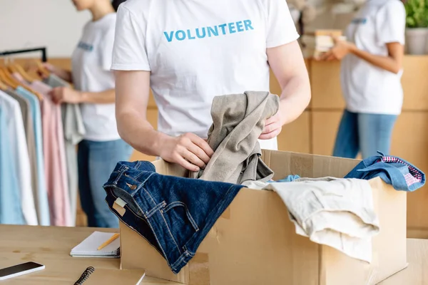 Cropped View Volunteer Unpacking Cardboard Box Clothes — Stock Photo, Image