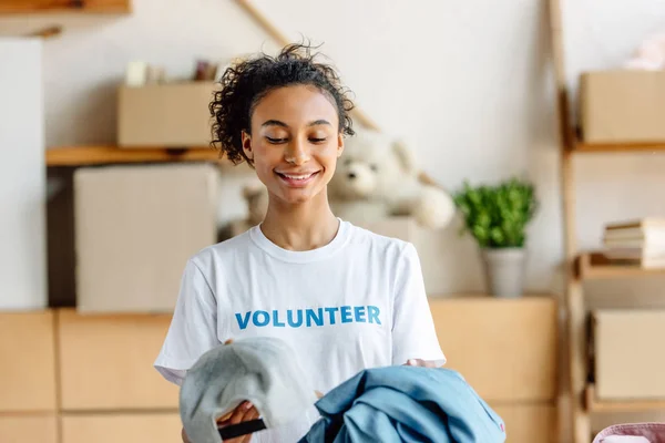 Beautiful African American Girl White Shirt Volunteer Inscription Holding Clothes — Stock Photo, Image
