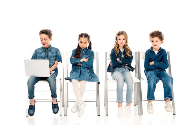 Smiling Boy Using Laptop While His Sad Friends Sitting Crossed — Stock Photo, Image