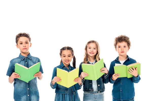 four kids in denim clothes holding books isolated on white