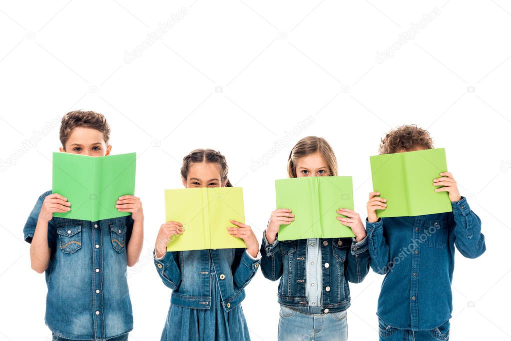 four kids in denim clothes holding books isolated on white