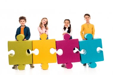full length view of kids with colorful jigsaw puzzles on white clipart