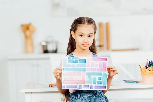 Cute Child Holding Paper Colorful Stripes While Standing Table Home — Stock Photo, Image