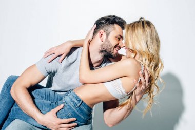 neşeli adam beyaz sarılma sırasında mutlu sarışın kadın bakıyor 