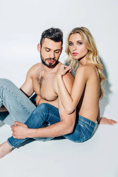 Handsome Man Touching Blonde Woman Jeans Sitting Looking Camera White — Stock Photo, Image