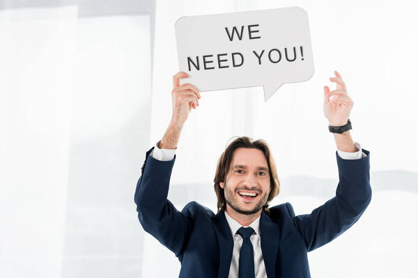 cheerful recruiter holding speech bubble with we need you lettering 