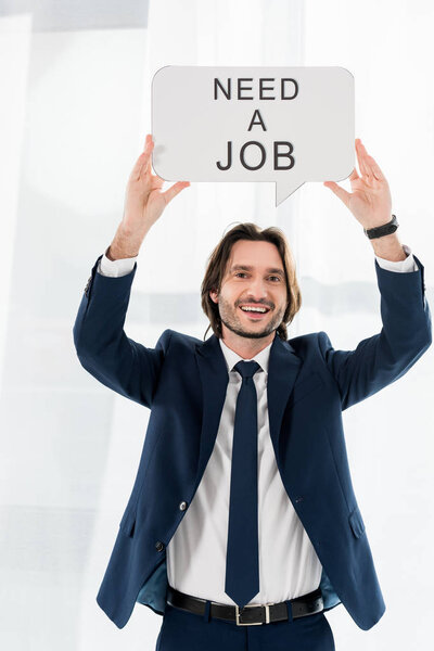 cheerful employee holding speech bubble with need a job lettering 