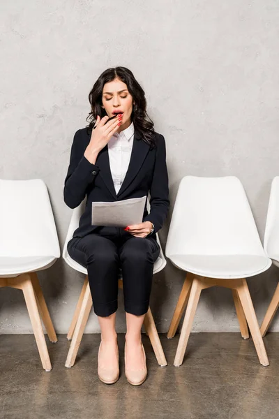 Tired Brunette Woman Looking Paper Yawning While Sitting Chair — Stock Photo, Image