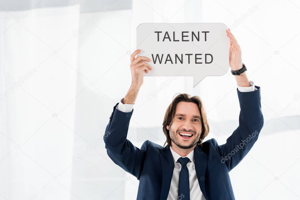 cheerful recruiter holding speech bubble with talent wanted lettering 