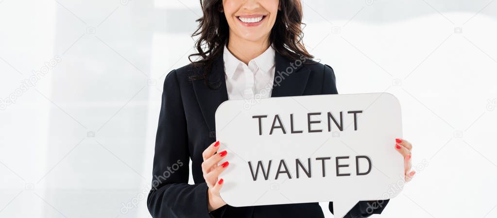 panoramic shot of cheerful recruiter holding speech bubble with talent wanted lettering 