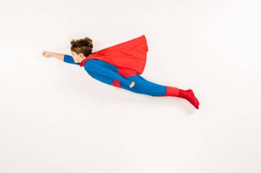 top view of adorable kid in super hero costume flying on white  clipart