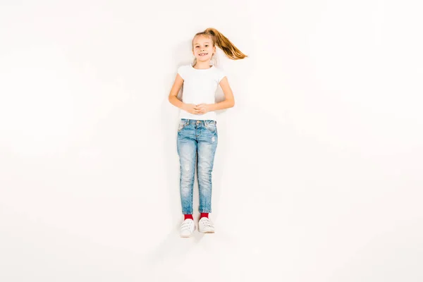 Top View Happy Kid Clenched Hands Lying White — Stock Photo, Image