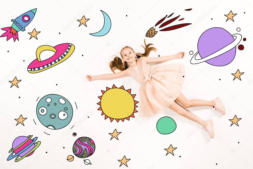 top view of cheerful kid in pink dress flying in space on white 