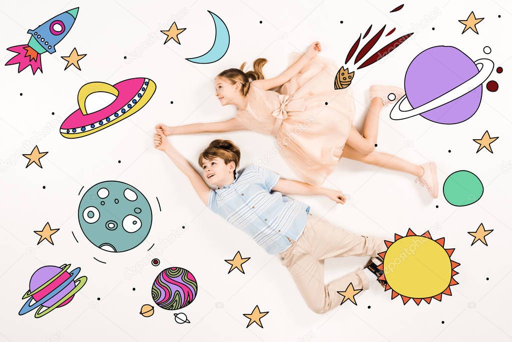 top view of cheerful kids gesturing while flying in space 