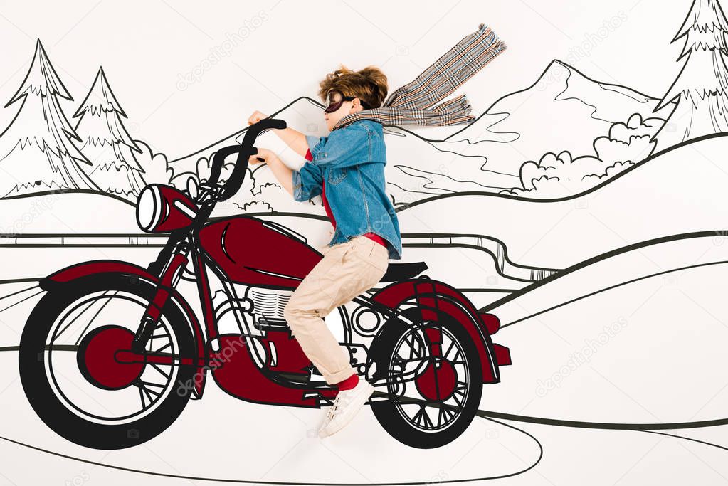 top view of kid in super hero mask driving motorcycle in mountains on white 