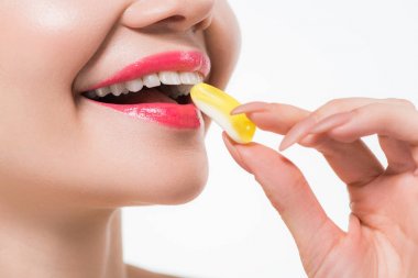 beyaz izole jöle şeker yiyen neşeli kadın kırpılmış görünümü 