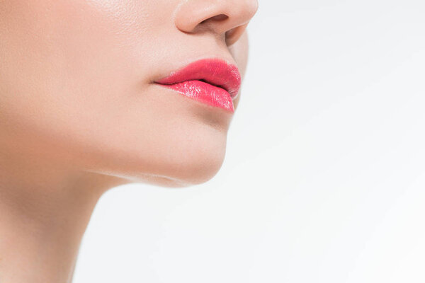 cropped view of young woman with pink lips isolated on white 