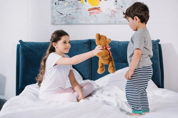 Happy Kid Smiling While Holding Teddy Bear Toddler Brother Bedroom — Stock Photo, Image