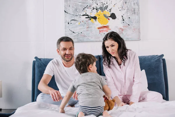 Happy Husband Wife Looking Toddler Son Bed — Stock Photo, Image