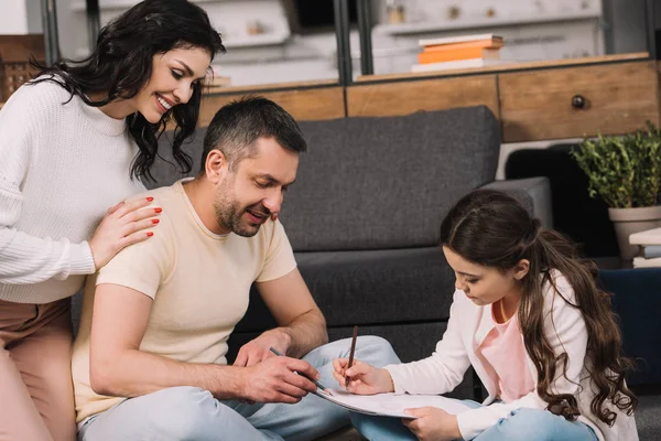 Happy Parents Looking Cute Daughter Drawing Paper Living Room — Stock Photo, Image