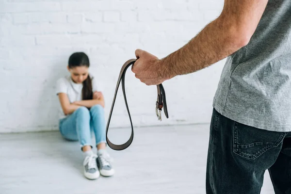 Cropped View Father Holding Belt Sad Daughter Sitting Floor — Stock Photo, Image