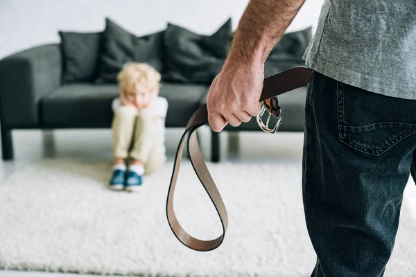 Partial View Abusive Father Holding Belt Sad Son Sitting Carpet — Stock Photo, Image
