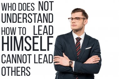 handsome businessman standing with crossed arms near who doesn't understand how to lead himself cannot lead others lettering on white  clipart