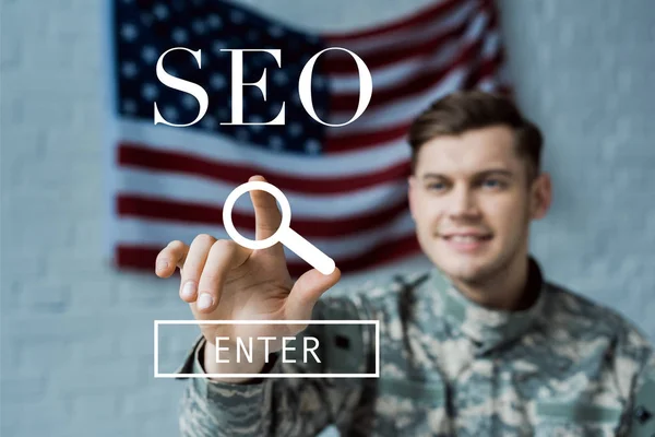 Selective Focus Happy Man Military Uniform Pointing Finger Seo Lettering — Stock Photo, Image