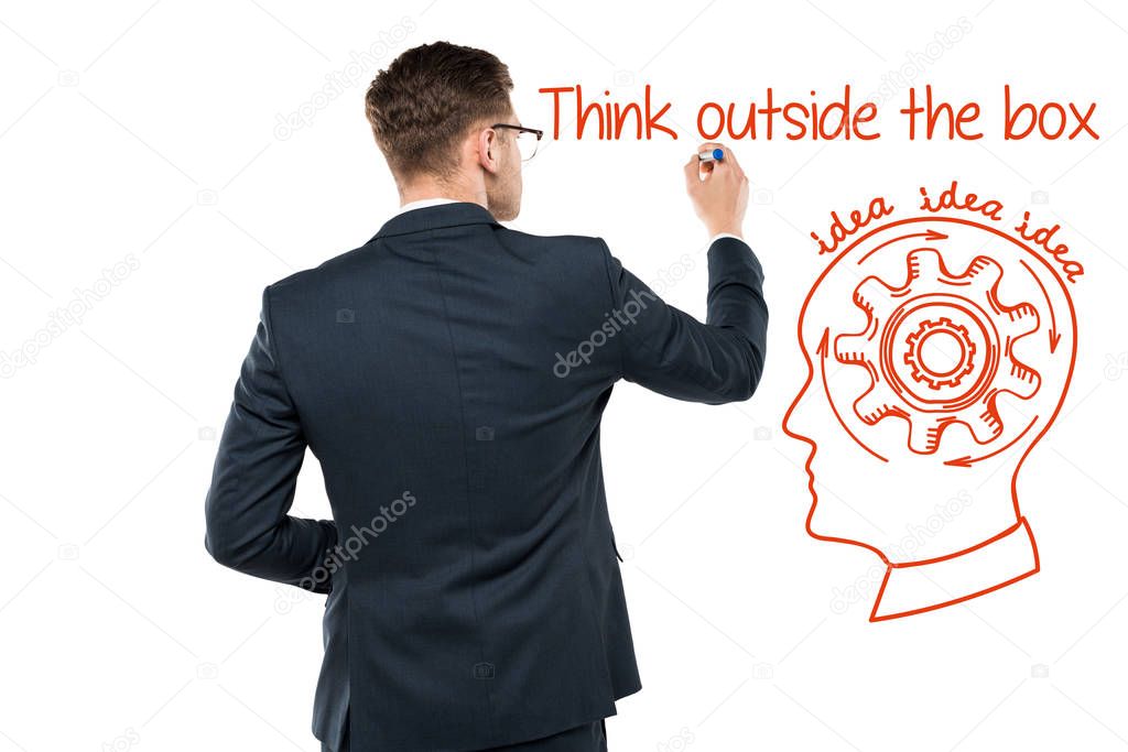 back view of businessman holding marker pen near think outside the box lettering on white 
