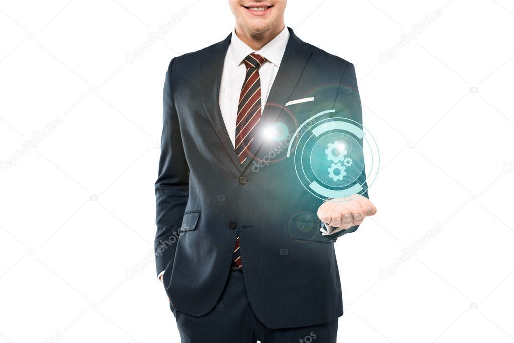 cropped view of cheerful man in suit smiling and gesturing near cogwheel icon on white