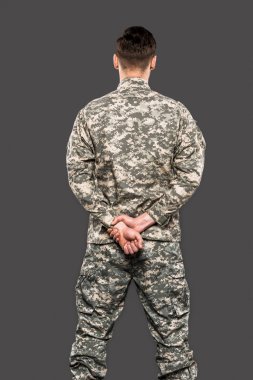 back view of soldier standing isolated on grey  clipart