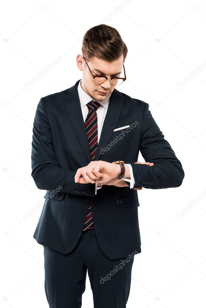 handsome businessman in glasses looking at watch isolated on white 