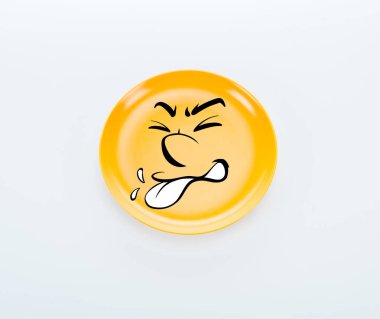 top view of shiny yellow plate with disgusted smiley on white background clipart