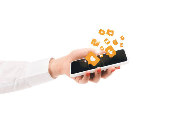 cropped view of woman holding smartphone with social media icons isolated on white