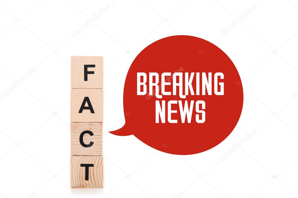 black fact word made of wooden blocks near red speech bubbles with breaking news lettering isolated on white