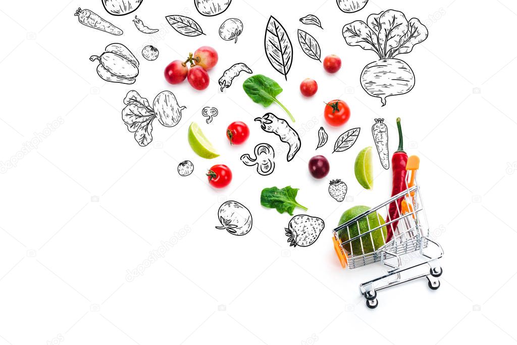 scattered fruits and vegetables with black and white illustration near decorative shopping cart isolated on white