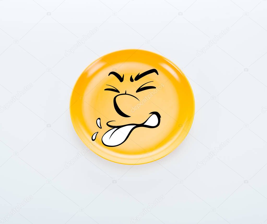 top view of shiny yellow plate with disgusted smiley on white background
