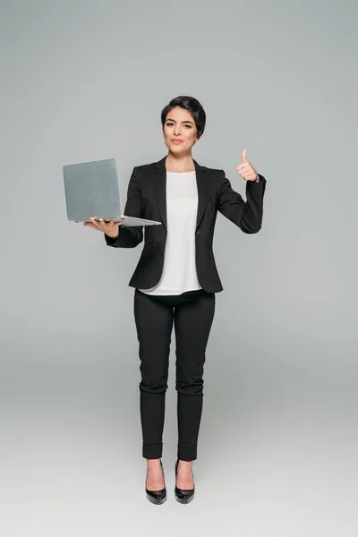 Beautiful Mixed Race Businesswoman Holding Laptop Showing Thumb Grey Background — Stock Photo, Image