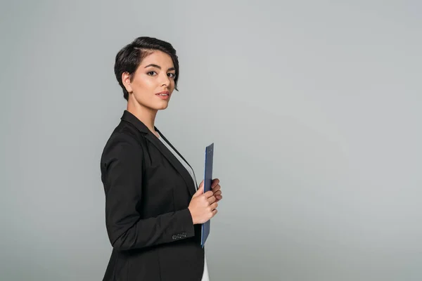Beautiful Mixed Race Businesswoman Holding Clipboard Looking Camera Isolated Grey — Stock Photo, Image