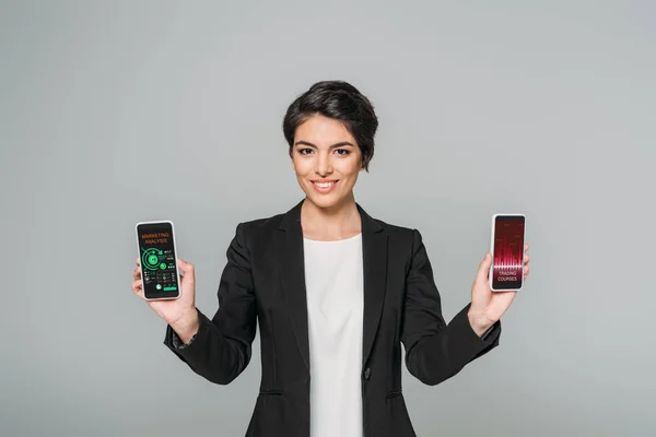 Smiling Mixed Race Businesswoman Holding Smartphones Trading Courses Marketing Analysis — Stock Photo, Image