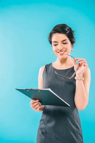 Cheerful Mixed Race Businesswoman Holding Glasses While Looking Clipboard Isolated — Stock Photo, Image
