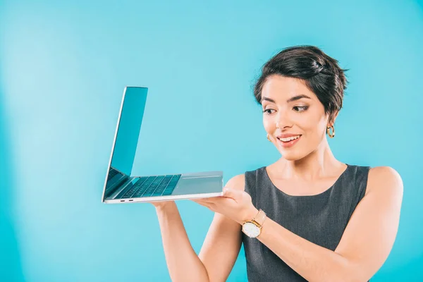 Cheerful Mixed Race Businesswoman Grey Dress Holding Laptop Blue Background — Stock Photo, Image