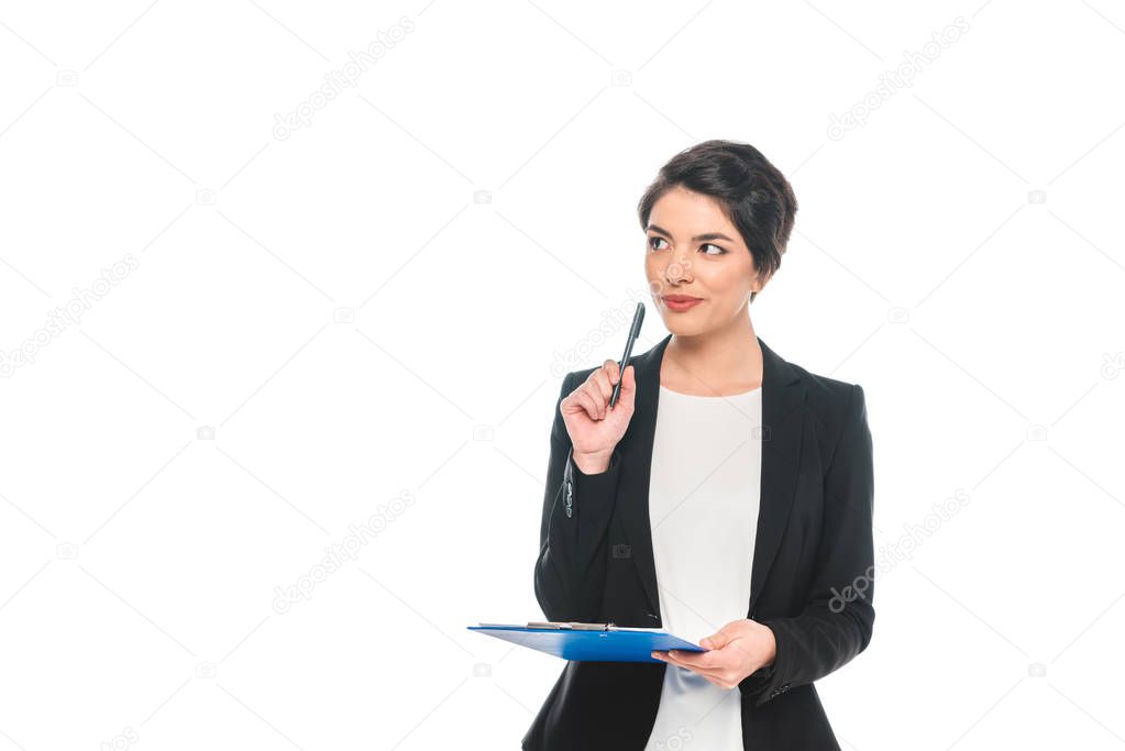 dreamy mixed race businesswoman holding pen and clipboard and looking away isolated on white